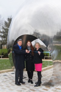 Three people in front of artwork